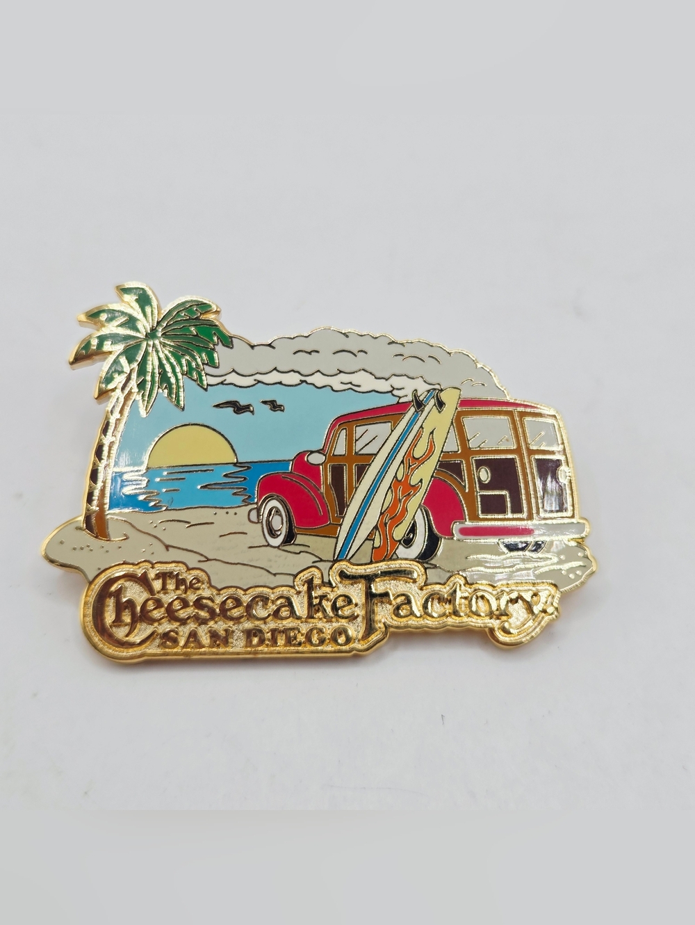 CHEESECAKE FACTORY PIN SAN DIEGO WOODY WITH SURFBOARDS PALM TREE SUNSET RARE LE